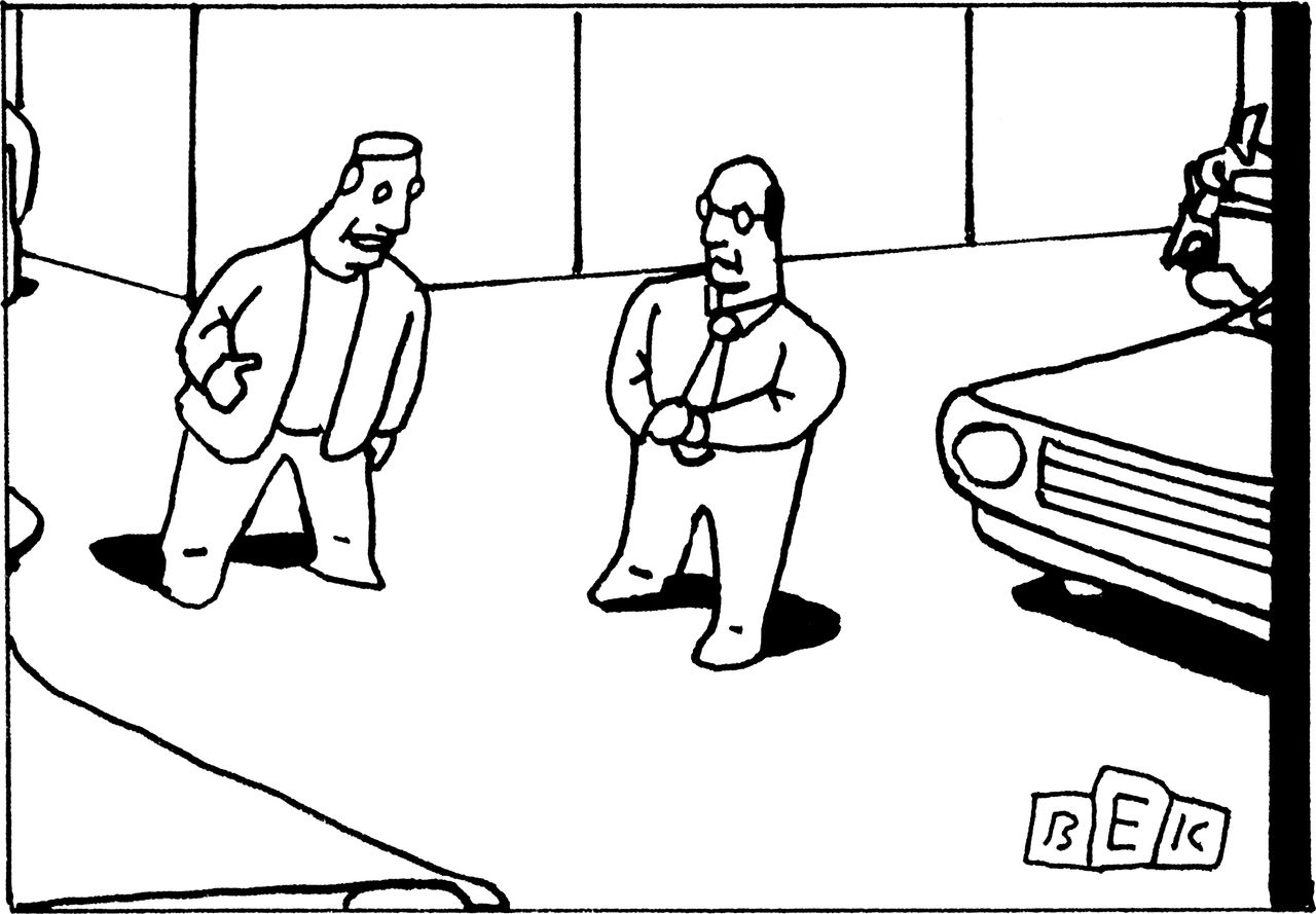 Man talking to salesman at car dealership.